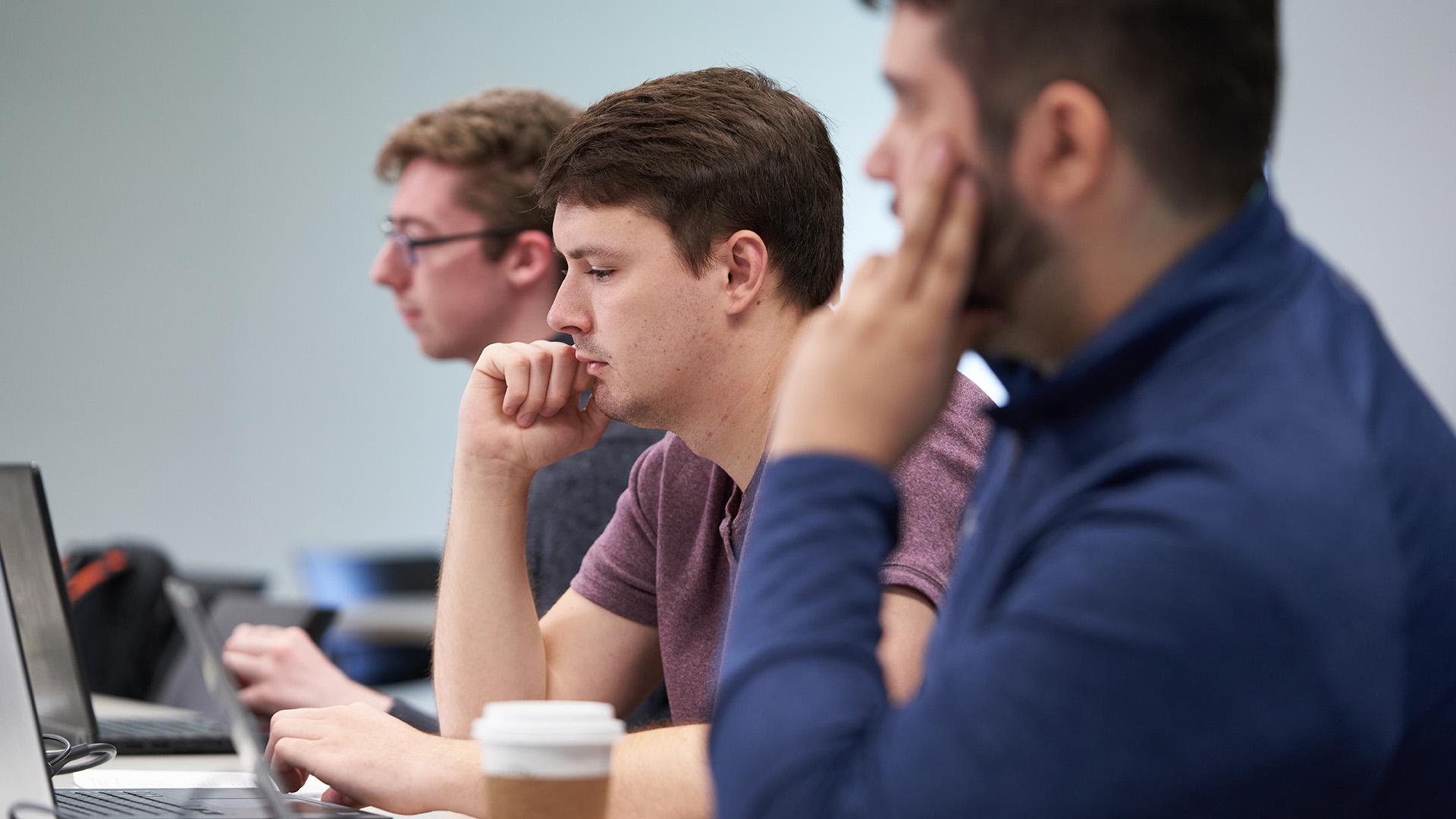 Business students in class with laptops